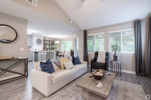 A modern living room with a white sofa and a coffee table.