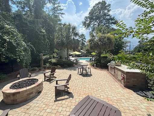 A backyard with a fire pit and patio furniture.