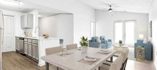 A modern kitchen with a dining table set for four.