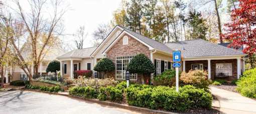 A house with a blue sign in front of it.