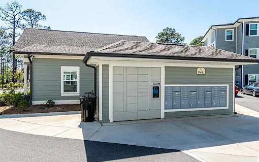 A grey and white garage with a mailbox on the right side.