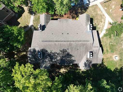 An aerial view of a building surrounded by trees.