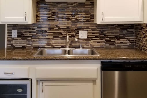 kitchen with marble counter and tiled backsplash