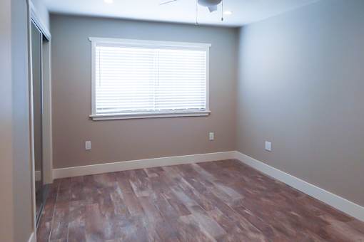 A room with a window and a ceiling fan.