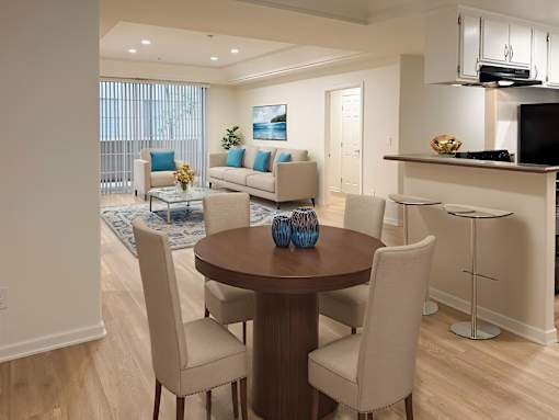 A modern dining room with a round table and chairs.