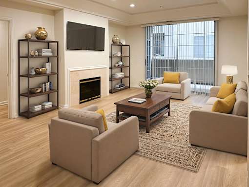 A living room with a fireplace, a television, and a couch.