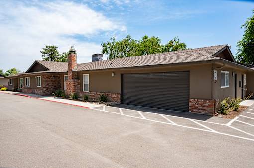 A building with a parking lot in front of it.