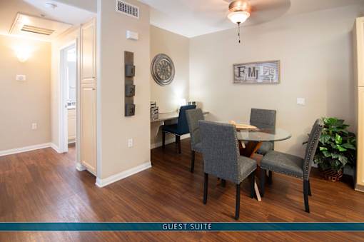 A dining room with a table and chairs.