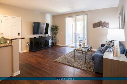 A living room with a fireplace and a flat screen TV.