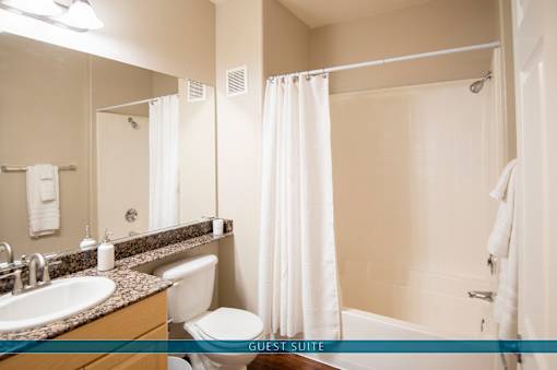 A bathroom with a sink, toilet, and bathtub.