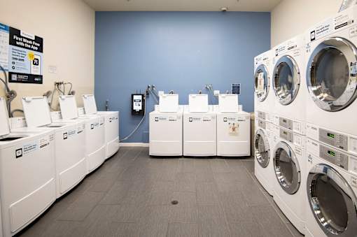 A row of washing machines in a laundromat.