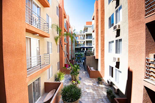 A sunny day in a courtyard surrounded by buildings.