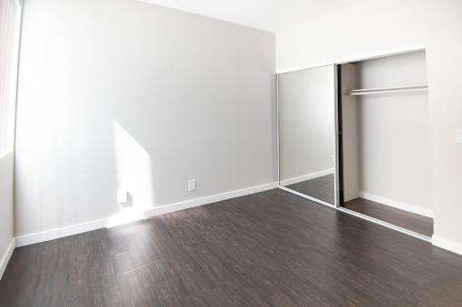 A room with a wooden floor and white walls.