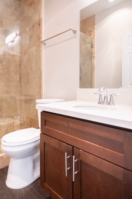A white toilet sits next to a sink in a bathroom.