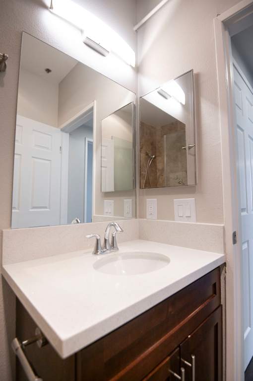 A bathroom with a sink and mirror.