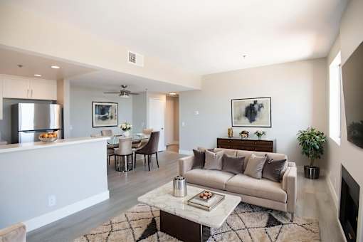 A modern living room with a white couch and a coffee table.