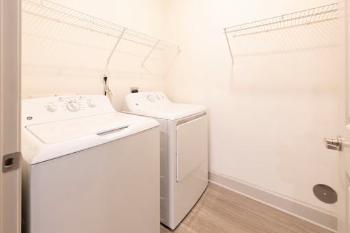 A white washing machine and dryer in a small laundry room.
