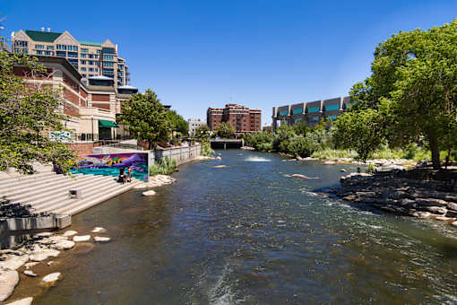 A river flows through a city with buildings on both sides.