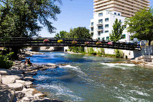 A bridge over a river with people walking on it.