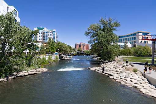 A river flows through a city with buildings on either side.
