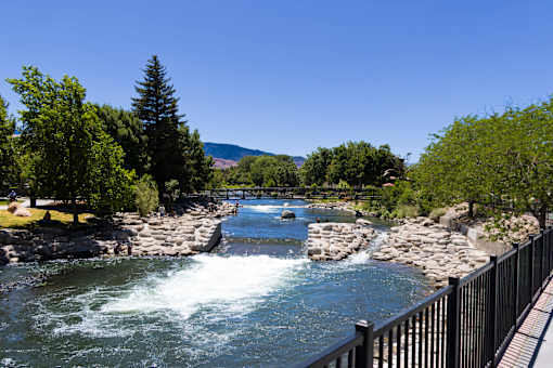 A river flows through a rocky landscape with a wooden walkway alongside.
