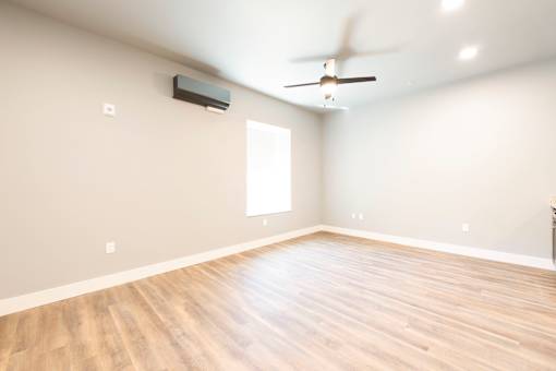 A room with a ceiling fan and a window.