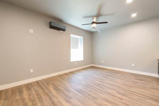 A room with a ceiling fan and a window.