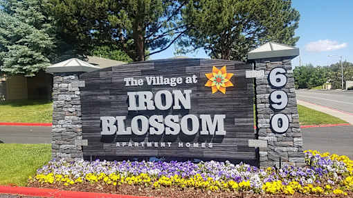 A sign for The Village at Iron Blossom Apartment Homes is shown.