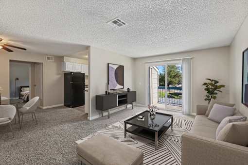 A living room with a black coffee table and striped rug.