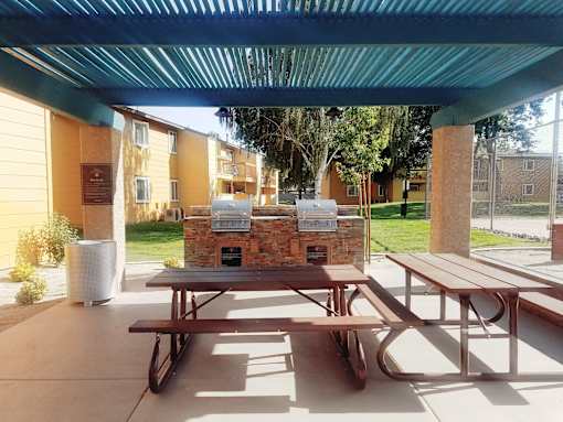 A picnic table is in the middle of a patio.