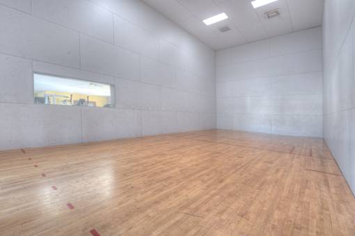 A room with wooden flooring and a window.