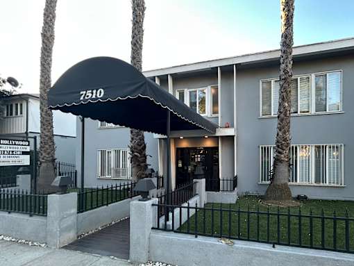 A building with a black awning that says 7510.