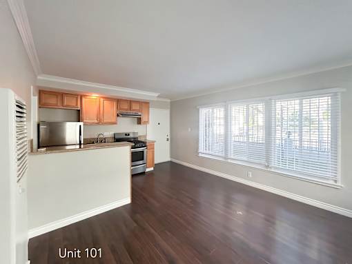 A kitchen with wooden floors and white walls.