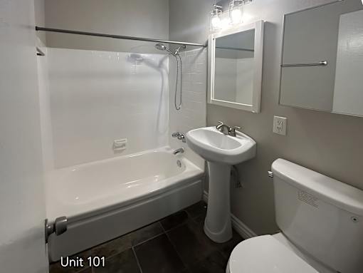 A white sink and tub in a bathroom.