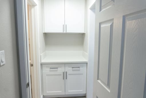 a white kitchen with white cabinets and white drawers