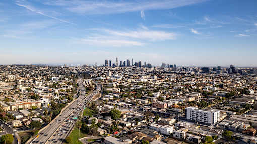 A cityscape with a highway running through it.