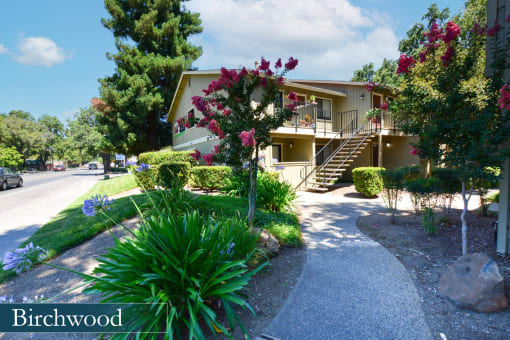 a house with a sidewalk and a street in front of it