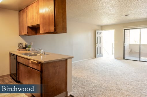 an empty kitchen and living room with a door to the living room and aoyer