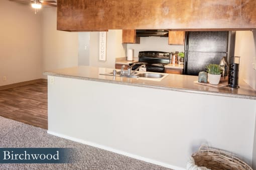 a view of a kitchen with a counter top and a sink