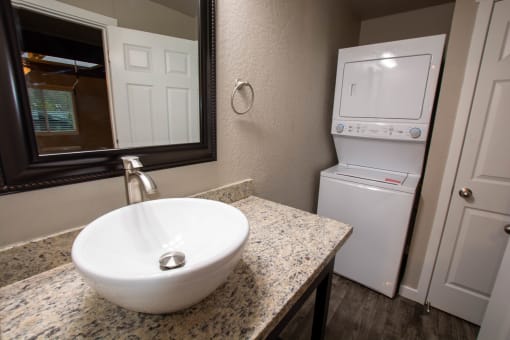 bathroom with vanity and stacked washer dryer