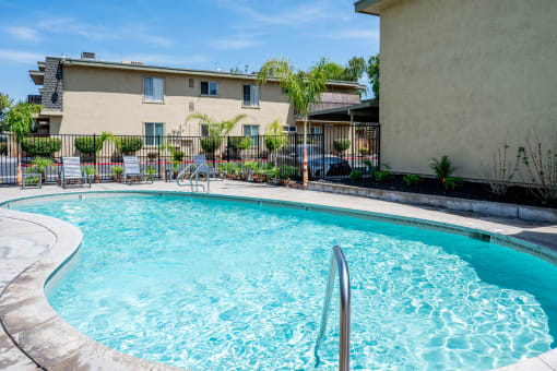a swimming pool with a building in the background