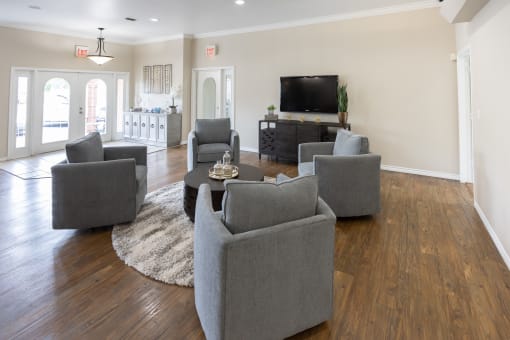 View of clubroom with seating, tv, and coffee bar.