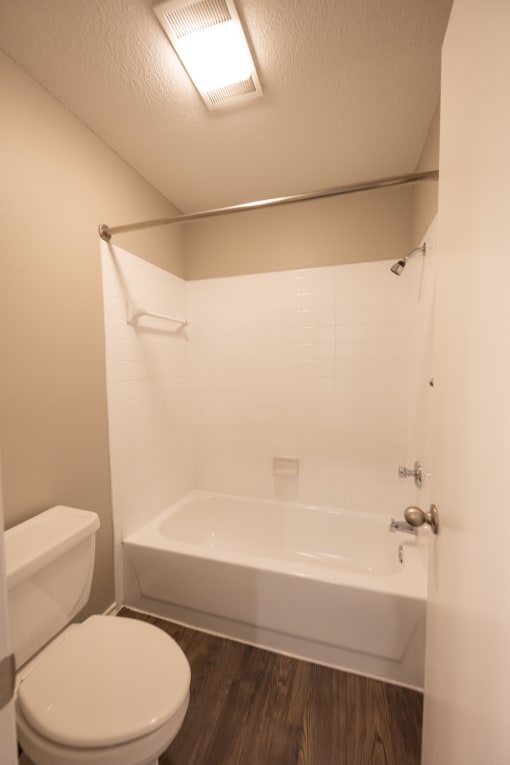 View of tiled tub shower combo in bathroom