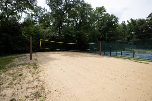 a tennis court with a yellow net in the middle of it