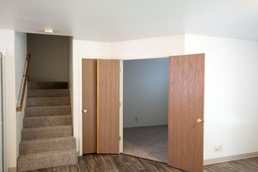 View of stairs leading to upstairs bedroom and view into downstairs bedroom