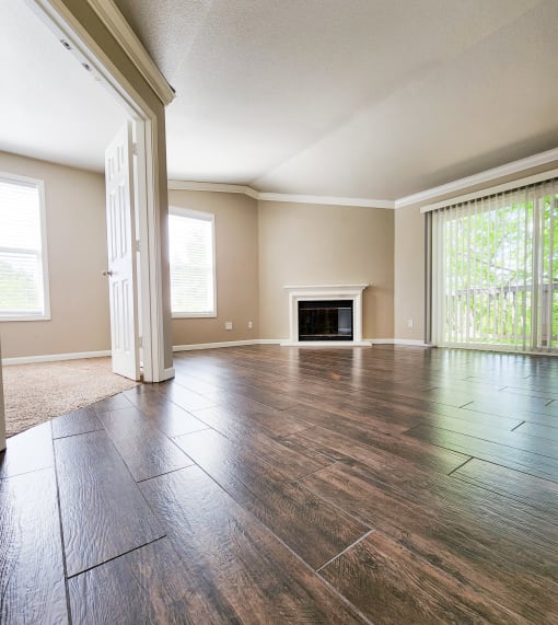 View into living area with view of fireplace, access to private balcony, and access to bedroom