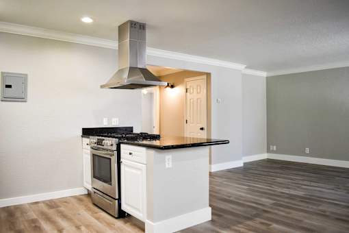 A modern kitchen with a stainless steel range hood.