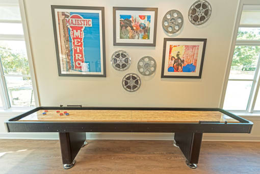 a pool table in a living room with pictures on the wall at Midtown Sam Houston Apartments, Huntsville