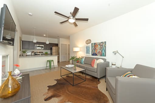 a living room with couches and a coffee table at Midtown Sam Houston Apartments, Huntsville, TX, 77340