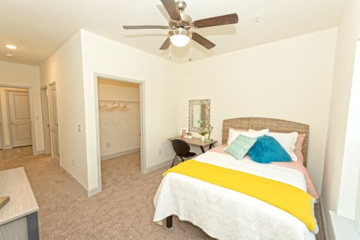 a bedroom with a bed and a ceiling fan at Midtown Sam Houston Apartments, Texas, 77340
